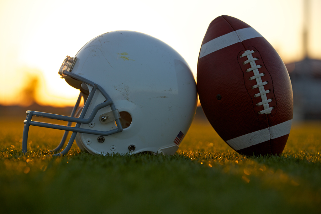 helmet and football on field
