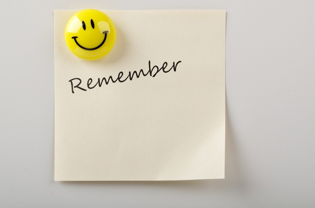"remember" sticky note with smiley face magnet
